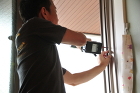 不二サッシ エコ引違い雨戸スピーディの取付けをする職人