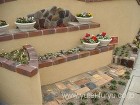 曲線の塗壁と古釜レンガの花壇 | 福岡・...