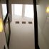 階段室<br />
北側トップライトから、天空光が射し込み、漆喰壁に光の粒子が反射して拡散。室全体が、優しい光に満たされる。