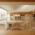 写真手前・奥：保育室  <br />
シースルーの大階段を挟んで保育室が対面する空間構成。