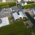 施設上空<br />
田圃を宅地に農地転用。敷地南側に建物を、北側には広場（プレイスペース）と店舗駐車場を配置。