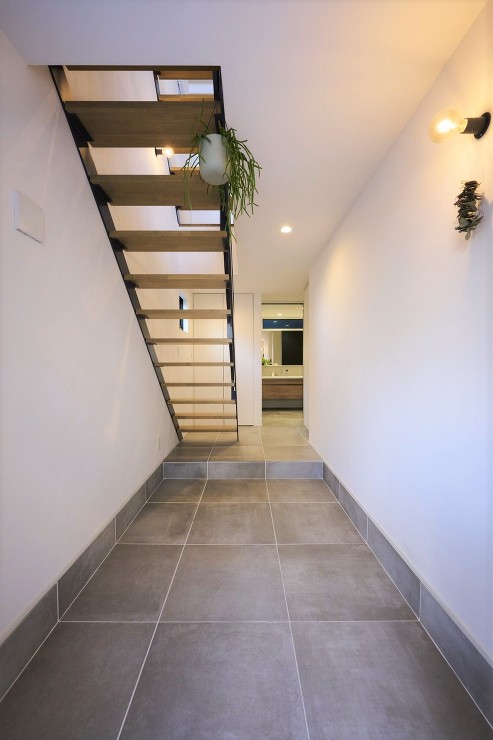 土間から室内まで同素材の床材を用いて広がりを演出しましたの画像