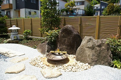 景石を背景に信楽焼の水鉢を