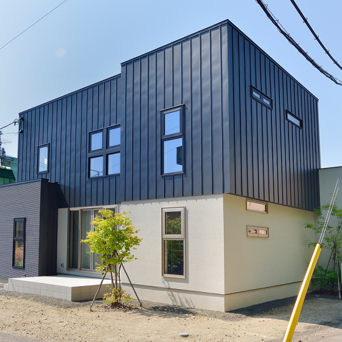 金属素材の外壁とアクセントに塗り壁を採用。お家の凸凹を上手くいかしたシックな外観。